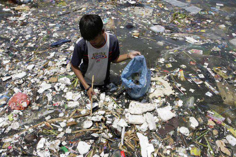 1536566322404219.jpg A boy collects plastic near a polluted coastline to sell in Manila.jpg